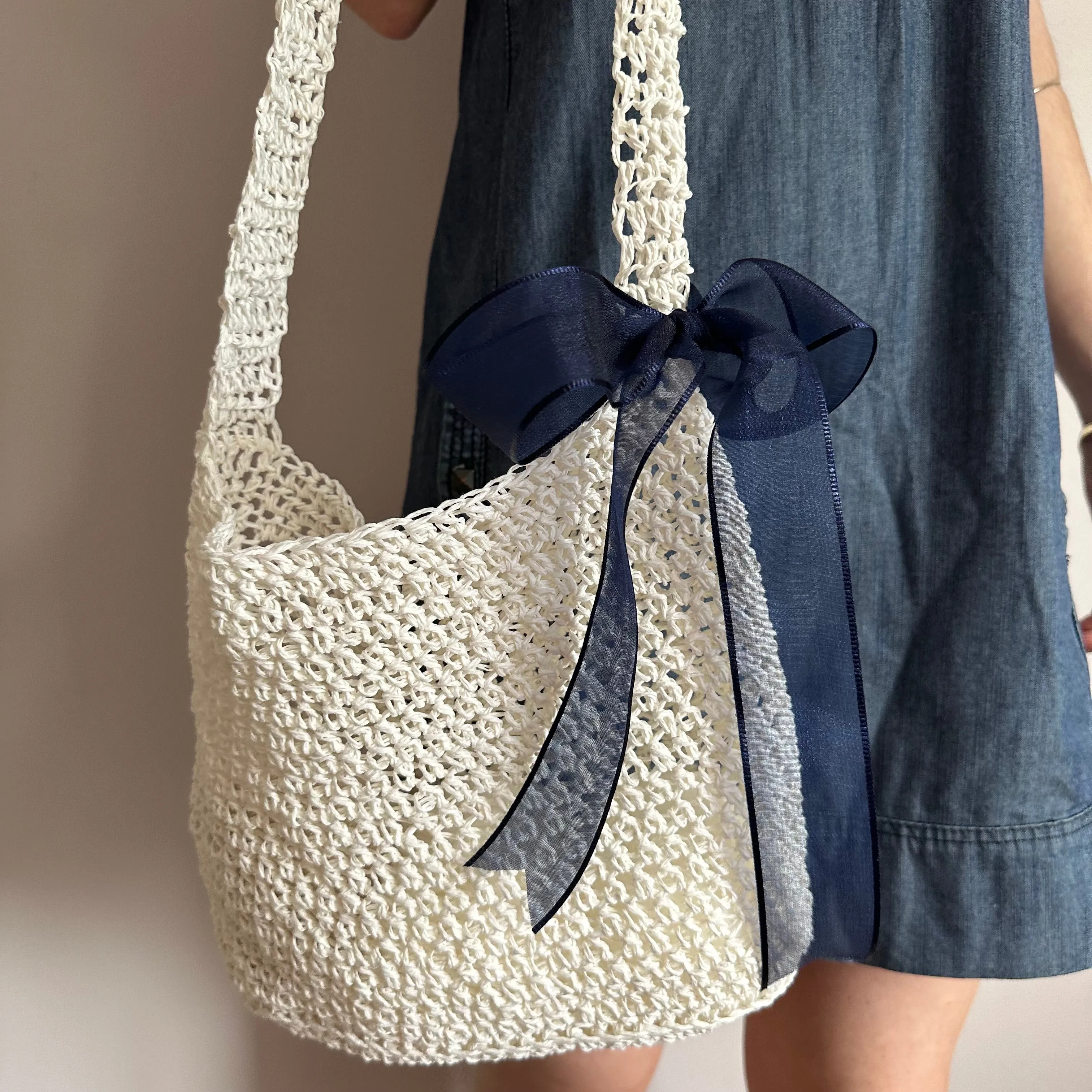 Handmade cream crochet straw bag with navy blue bow - can also be worn crossbody